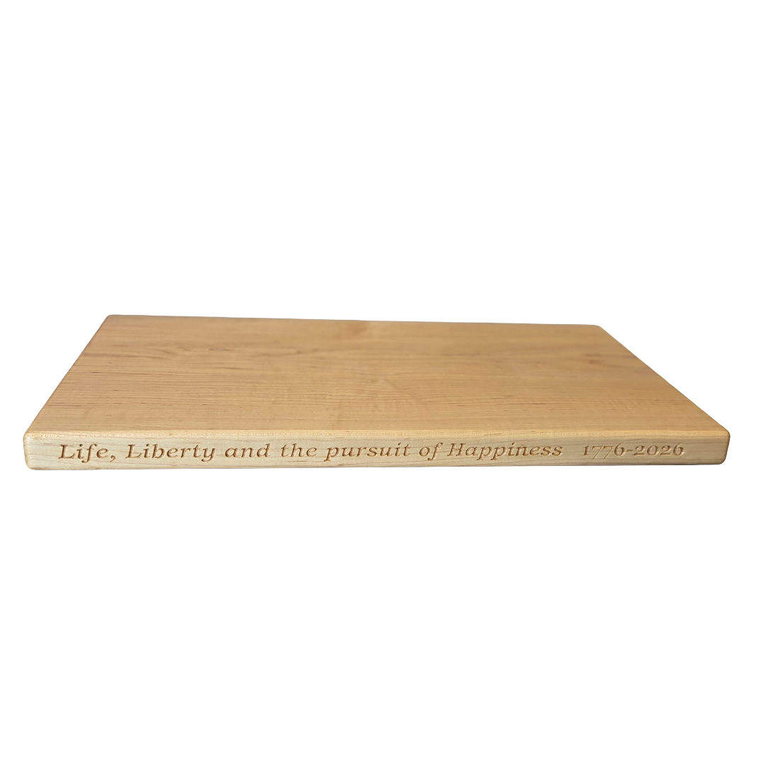 250th U.S.A. anniversary special maple cutting board by Treeboard with quotation from the Declaration of Independence: "Life, Liberty and the pursuit of Happiness." 1776-2026