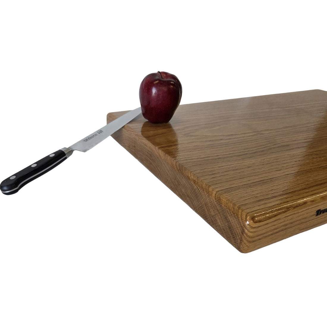 Extra-large cutting board by Treeboard with apple and knife. It&
