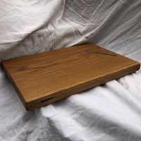 Our biggest chopping block yet is hewn from a solid slab of white oak and finished with raw linseed oil and Treeboard's exclusive board balm, made with linseed oil and carnauba wax.