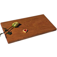 Large cherry chopping board by Treeboard with rose and heart-shaped cookie.