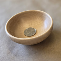 Small maple bowl by Treeboard with Canadian quarter showing moose.
