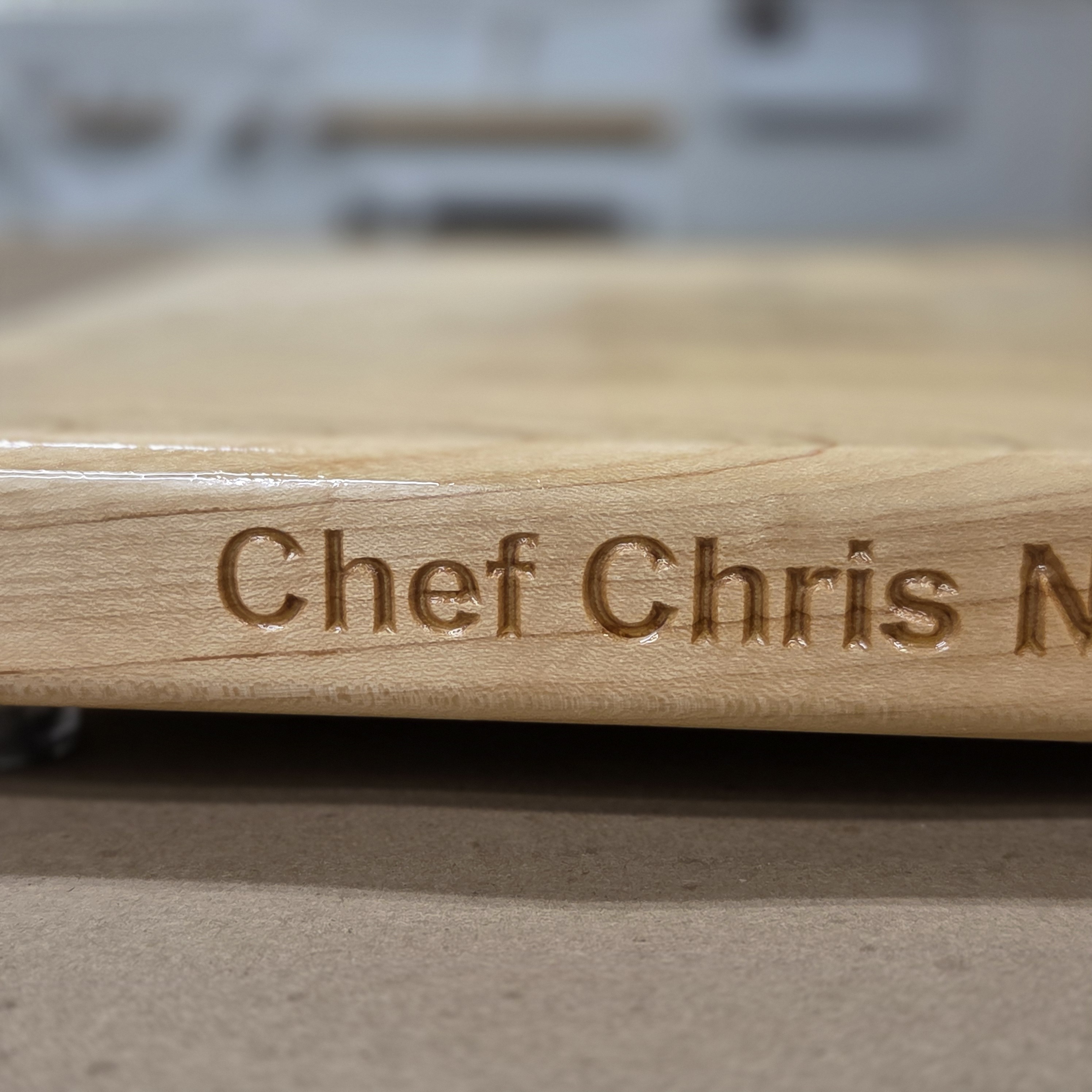 A hard maple cutting board by Treeboard engraved with custom text.