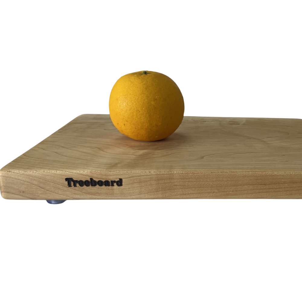 Medium maple cutting board with an orange