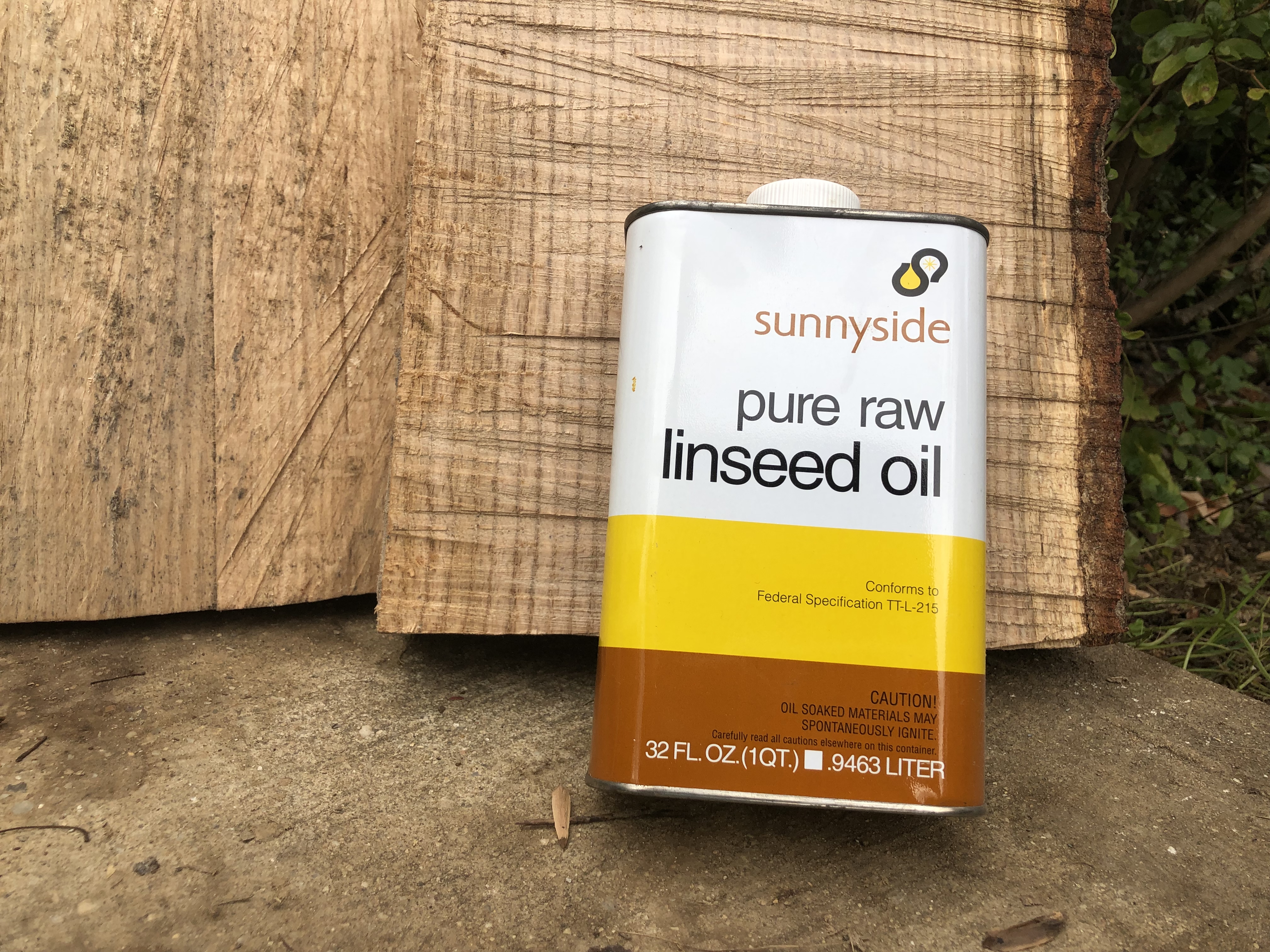 Linseed oil can in front of freshly sawn (and thirsty) oak slabs