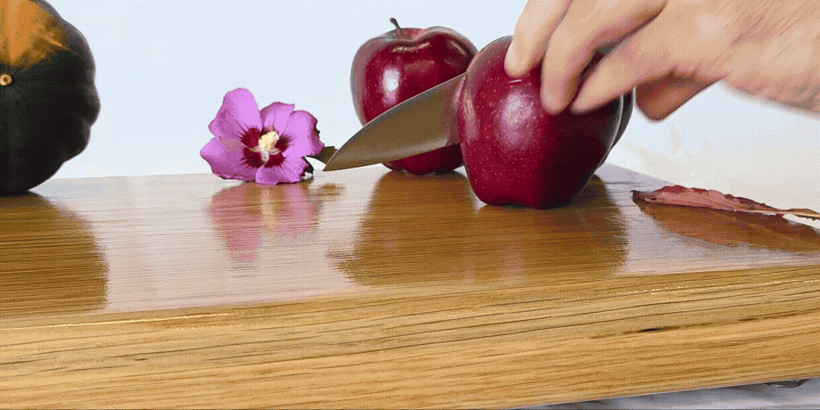 Knife slicing an apple on a Treeboard oak cutting board